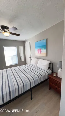 a bedroom with bed and window