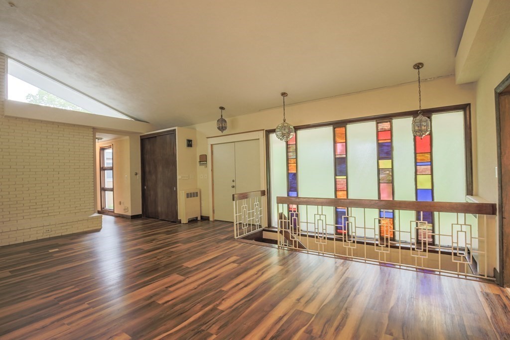 16 Bypass Road Lincoln, MA 01773 - Photo 3 of 31 a view of an empty room with wooden floor and a window