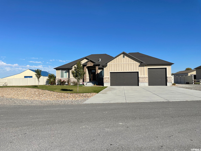 68 Hidden Acres Lane Erda, UT 84074 - Photo 1 of 1 View of front of property featuring a front yard and a garage
