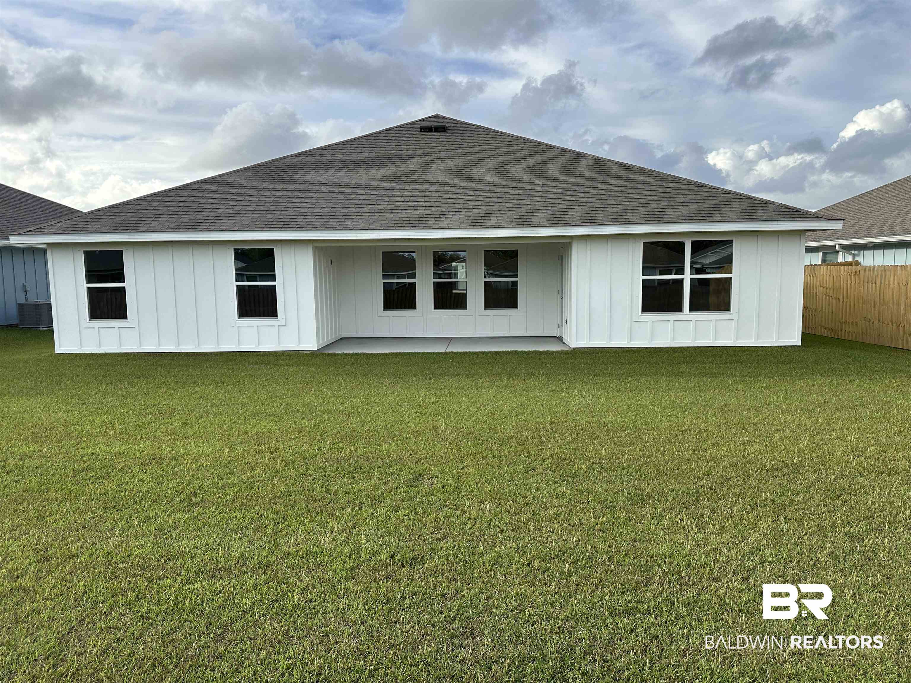 8850 Sea Star Circle Foley, AL 36535 - Photo 9 of 29 Rear view of house with central air condition unit and a lawn