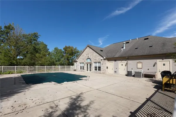 a view of a house with backyard and sitting area