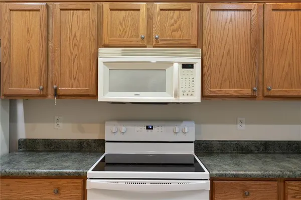 a stove top oven sitting inside of a kitchen
