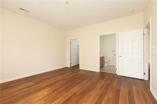 a view of a room with wooden floor