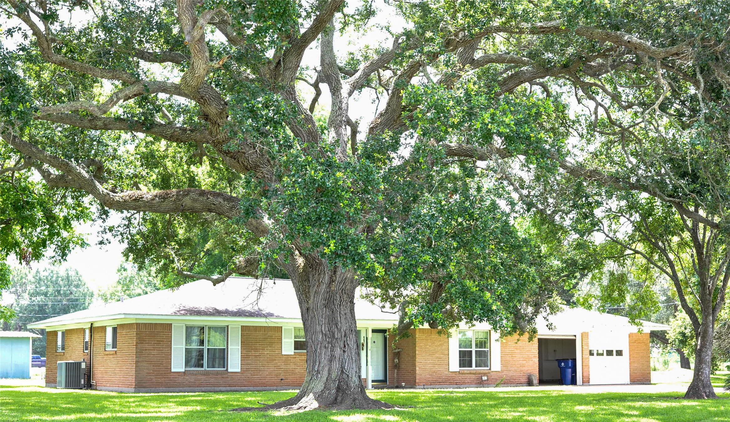 402 Peach Point Road Jones Creek, TX 77541 - Photo 1 of 32 Front of the home with mature trees