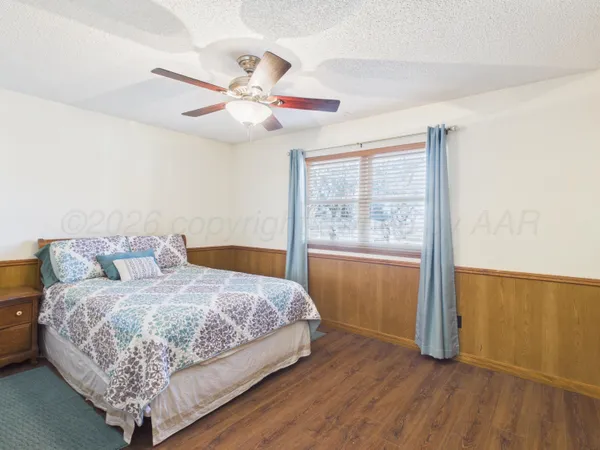 a bedroom with a large bed and a window