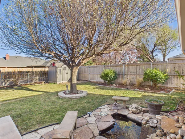 a view of a house with garden and sitting area