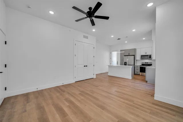 a kitchen with stainless steel appliances a refrigerator stove and microwave