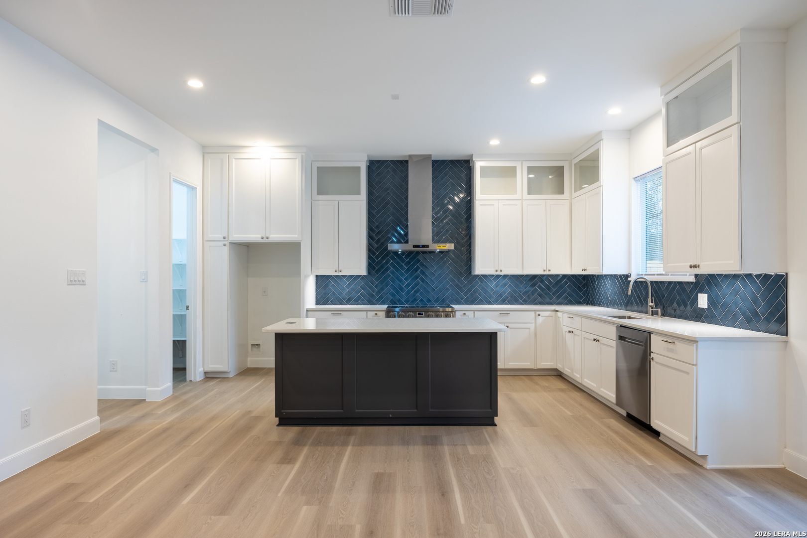8221 Old Austin Road Selma, TX 78154 - Photo 4 of 28 a large kitchen with stainless steel appliances granite countertop a sink and cabinets