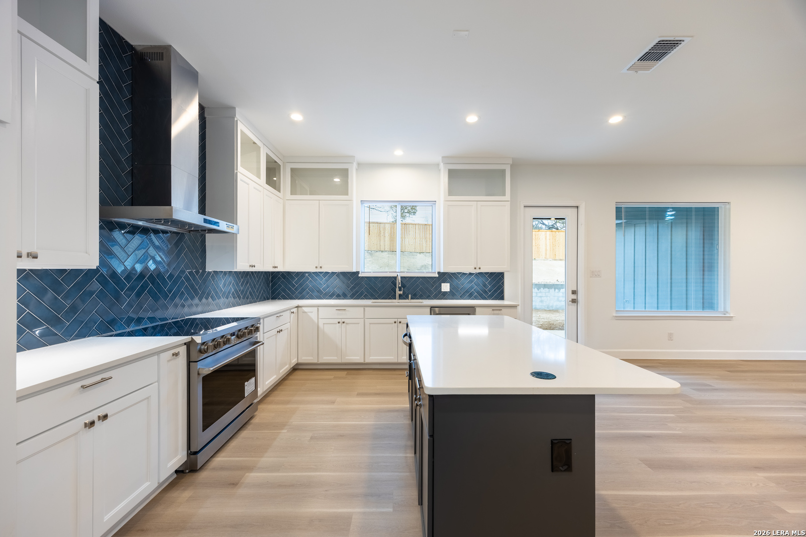 8221 Old Austin Road Selma, TX 78154 - Photo 5 of 28 a large kitchen with stainless steel appliances granite countertop a sink and cabinets