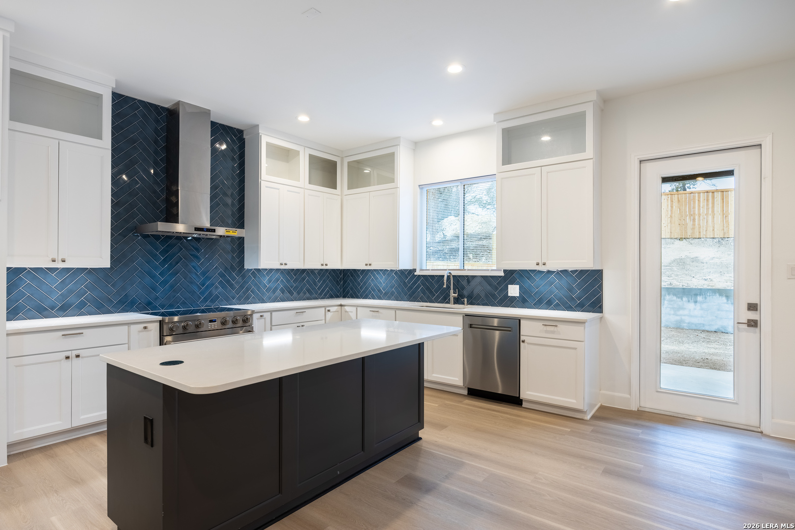 8221 Old Austin Road Selma, TX 78154 - Photo 6 of 28 a kitchen with a sink cabinets and wooden floor