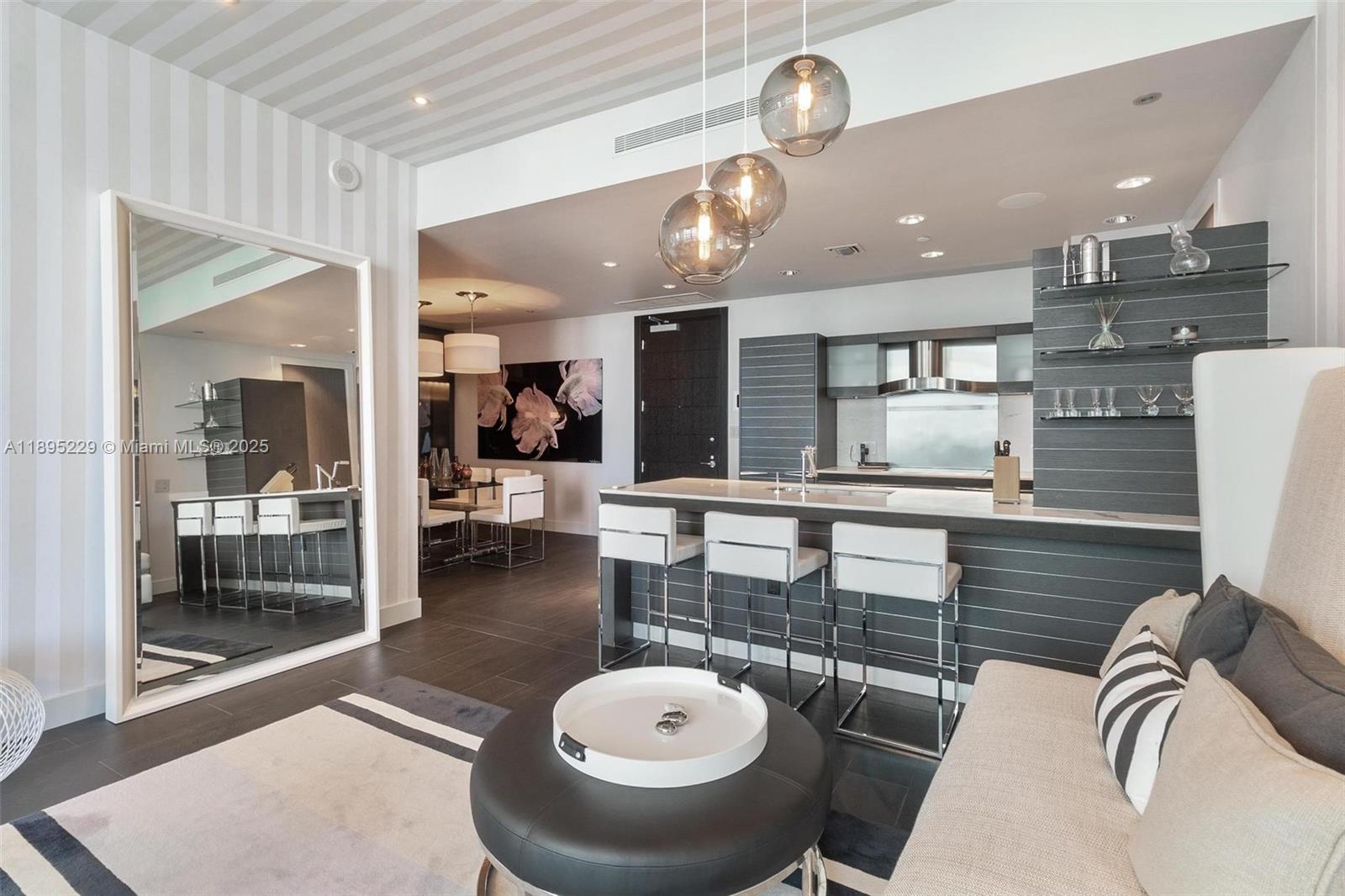 200 Biscayne Blvd Way, Unit 5211 Miami, FL 33131 - Photo 12 of 32 a living room with stainless steel appliances furniture and a floor to ceiling window