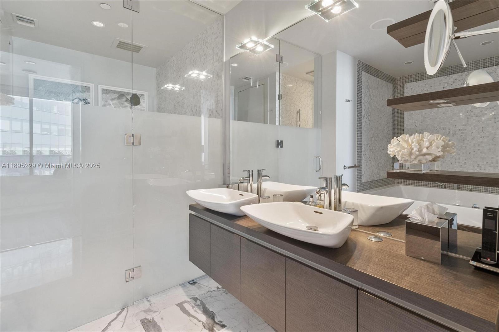 200 Biscayne Blvd Way, Unit 5211 Miami, FL 33131 - Photo 21 of 32 a bathroom with a double vanity sink and a mirror