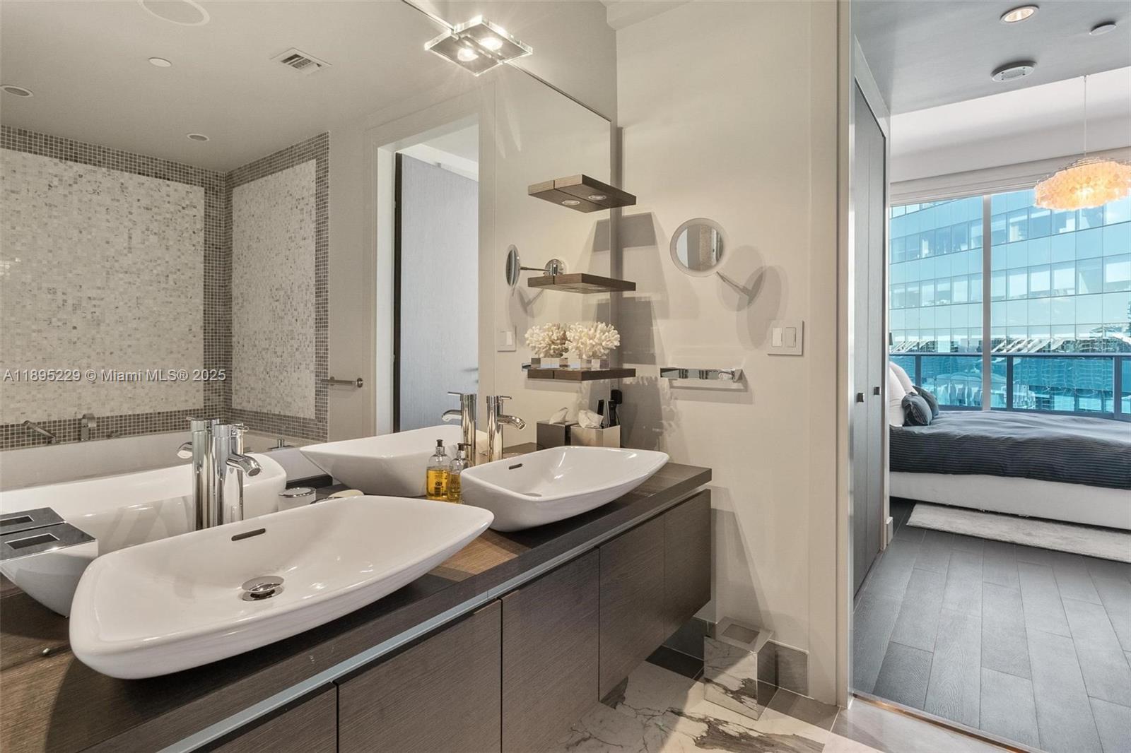 200 Biscayne Blvd Way, Unit 5211 Miami, FL 33131 - Photo 24 of 32 a bathroom with a double vanity sink mirror and tub