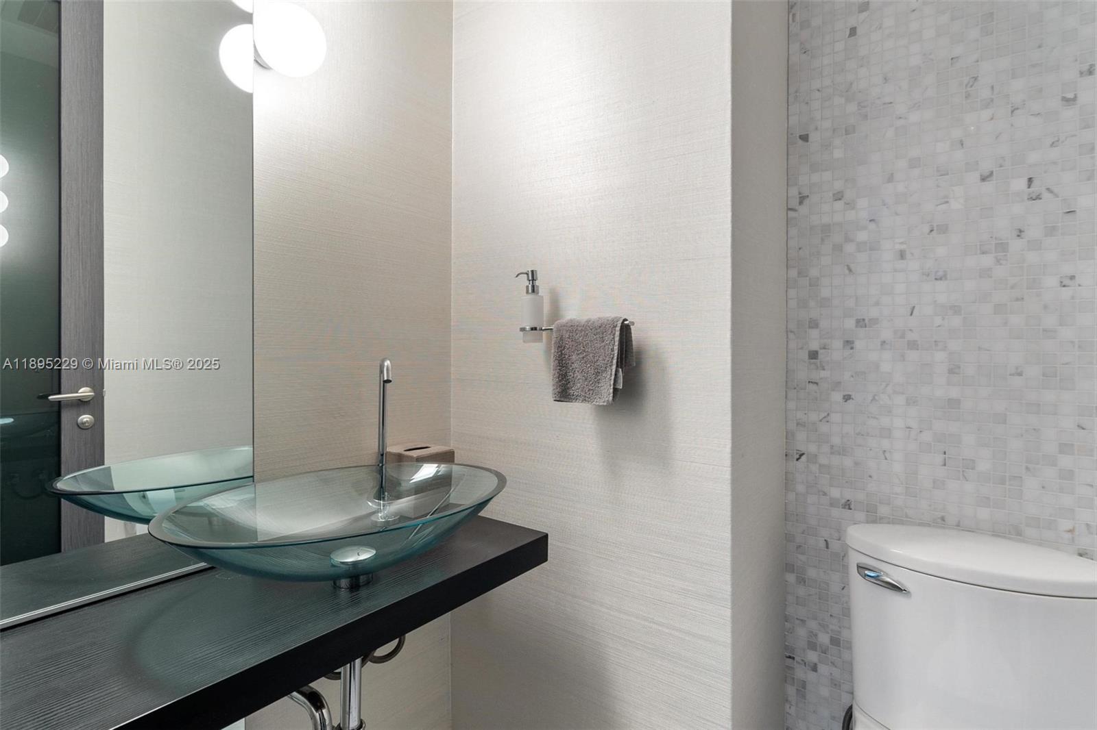200 Biscayne Blvd Way, Unit 5211 Miami, FL 33131 - Photo 31 of 32 a bathroom with a sink and a mirror