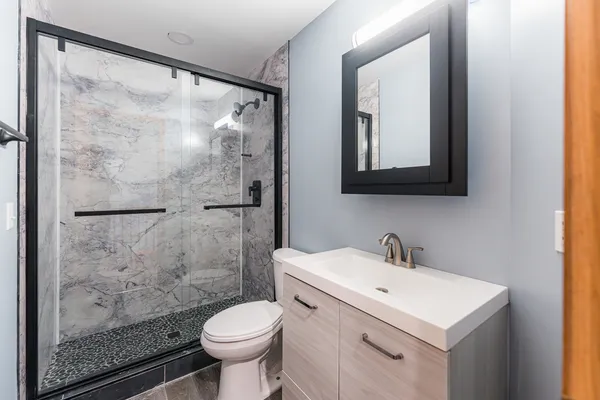 a bathroom with a sink toilet and shower