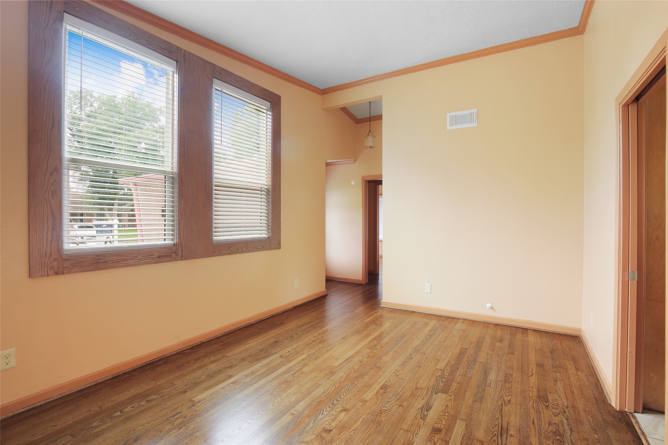 6923 Leader Street Houston, TX 77074 - Photo 2 of 19 a view of an empty room with wooden floor and a window