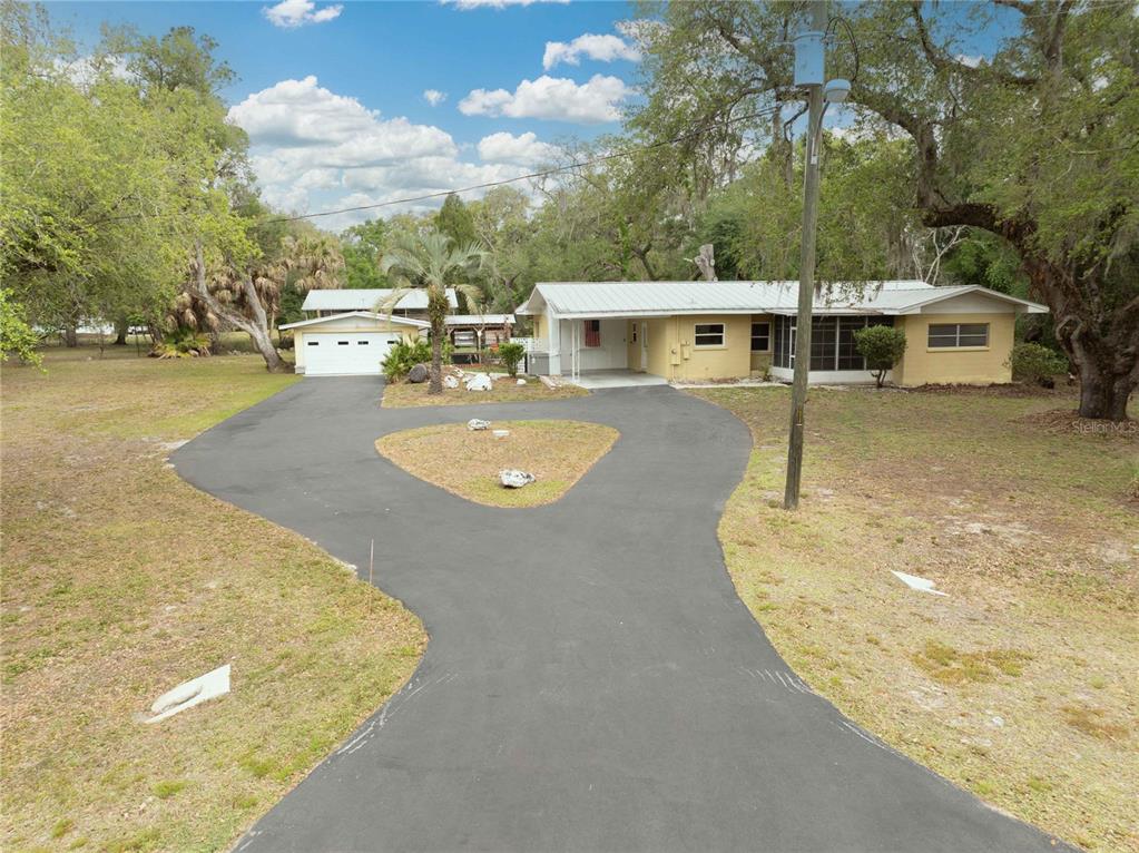 5175 Azalea Circle Dade City, FL 33523 - Photo 1 of 34 swimming pool view with a seating space