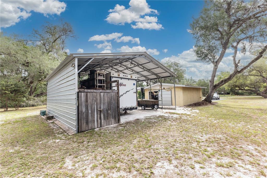 5175 Azalea Circle Dade City, FL 33523 - Photo 20 of 34 a view of a house with a patio
