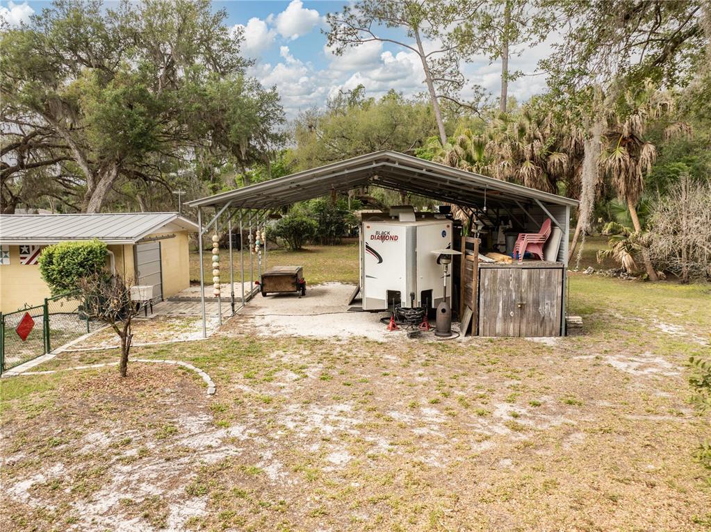 5175 Azalea Circle Dade City, FL 33523 - Photo 23 of 34 a view of a house with backyard and sitting area