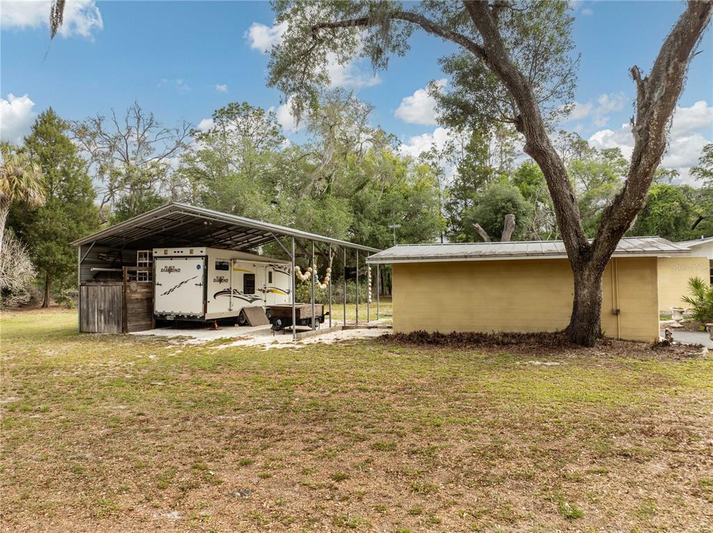 5175 Azalea Circle Dade City, FL 33523 - Photo 24 of 34 a big house with large trees in front of it