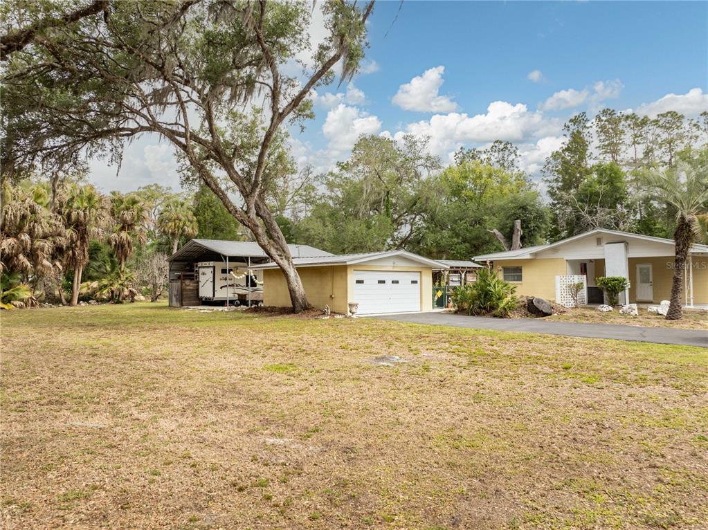 5175 Azalea Circle Dade City, FL 33523 - Photo 25 of 34 a front view of a house with a yard and trees