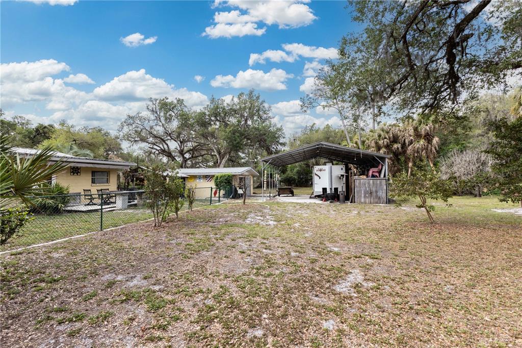 5175 Azalea Circle Dade City, FL 33523 - Photo 27 of 34 a front view of a house with a yard and trees