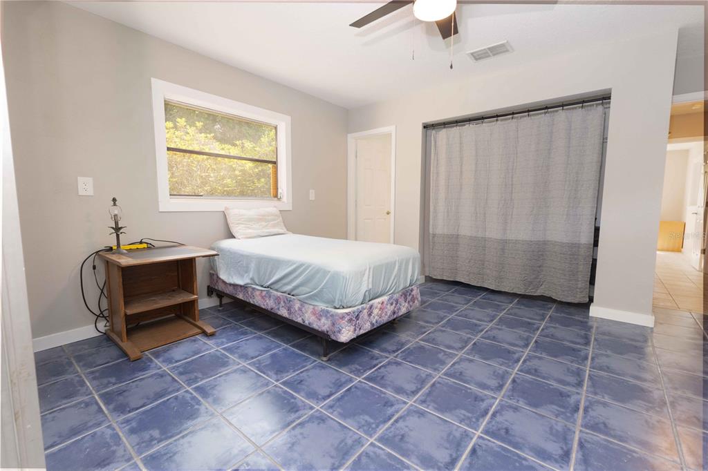 5175 Azalea Circle Dade City, FL 33523 - Photo 6 of 34 a bedroom with a bed and a window