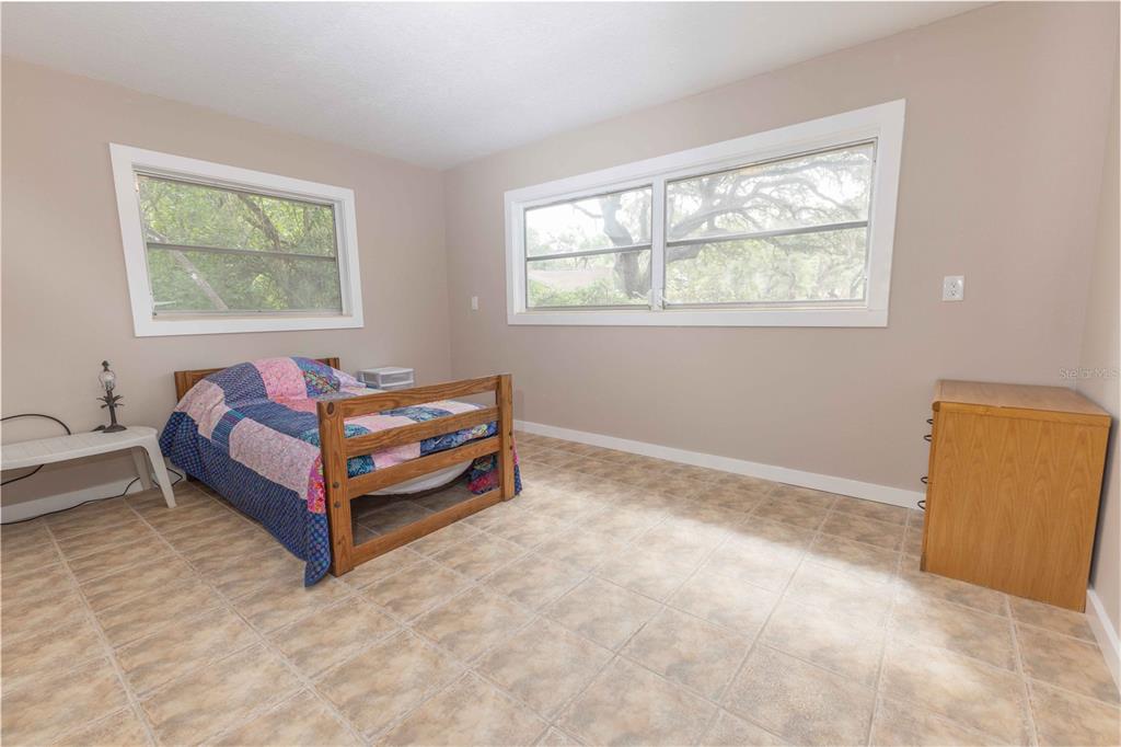 5175 Azalea Circle Dade City, FL 33523 - Photo 9 of 34 a room with furniture and a window