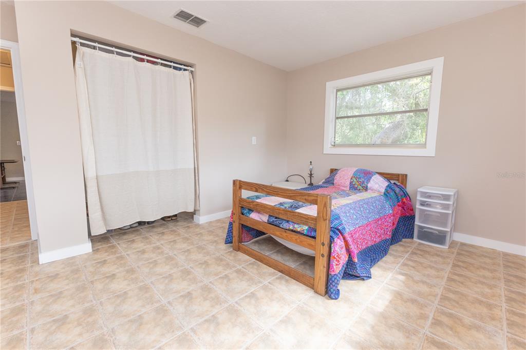 5175 Azalea Circle Dade City, FL 33523 - Photo 10 of 34 a bedroom with a bed and a window