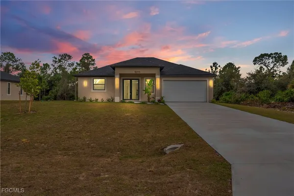 a front view of a house with a yard