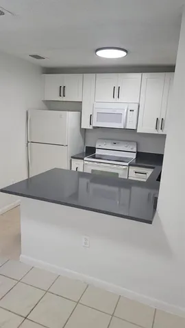 a view of cabinets and wooden floor