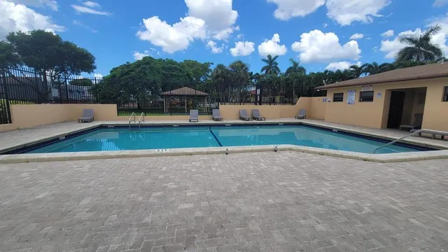 a view of a table and chairs under an umbrella