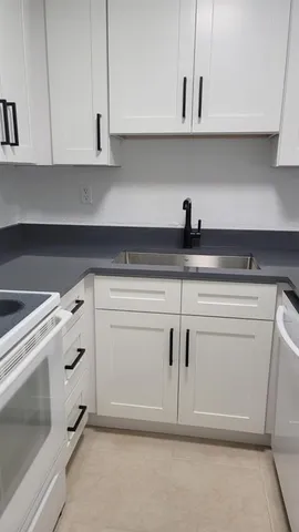 a stove top oven sitting inside of a kitchen
