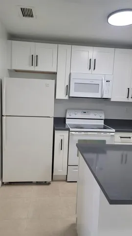 a view of cabinets and wooden floor