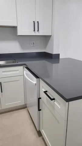 a view of hallway with a window and a washer