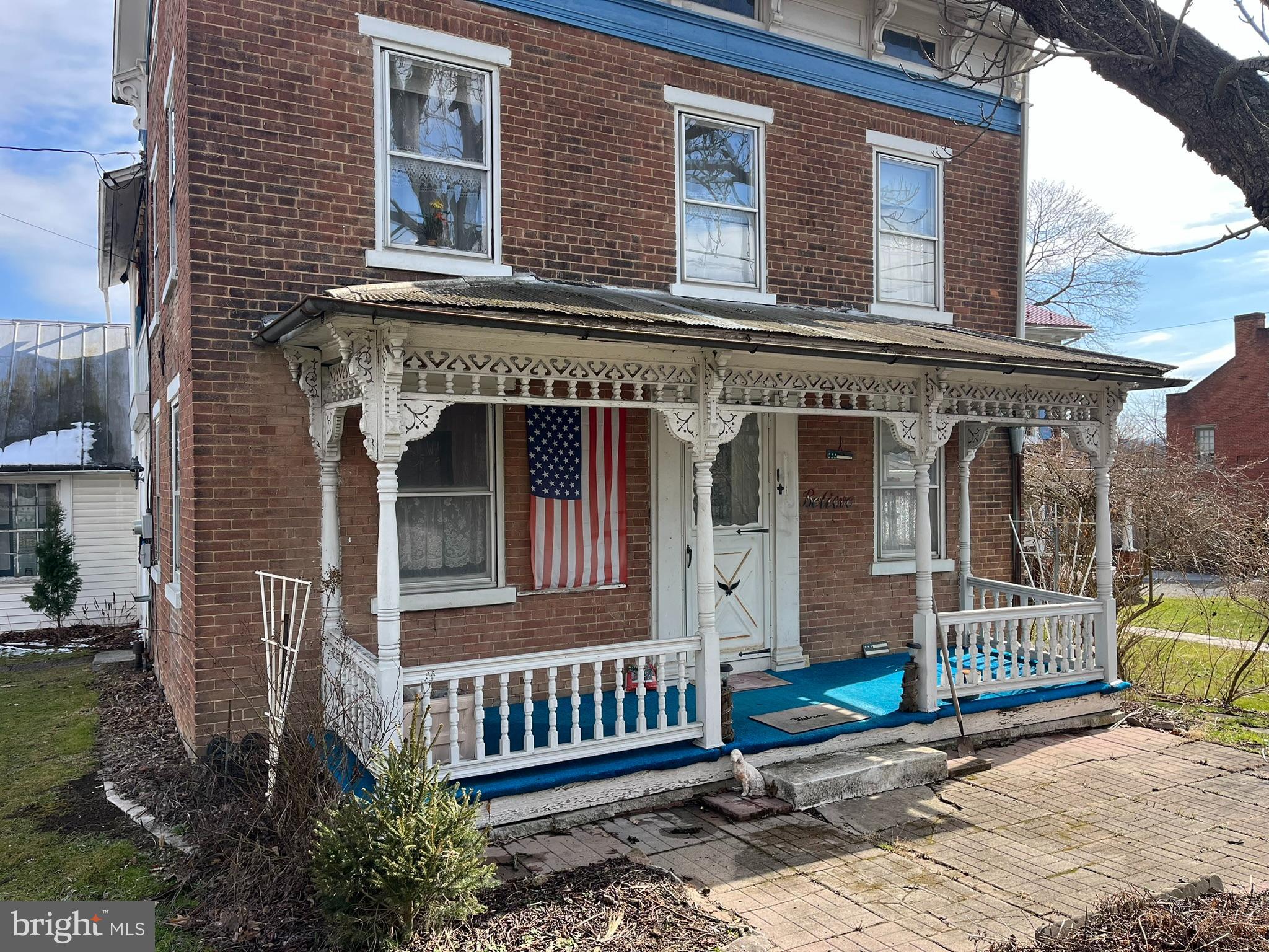 a front view of a house with a garden