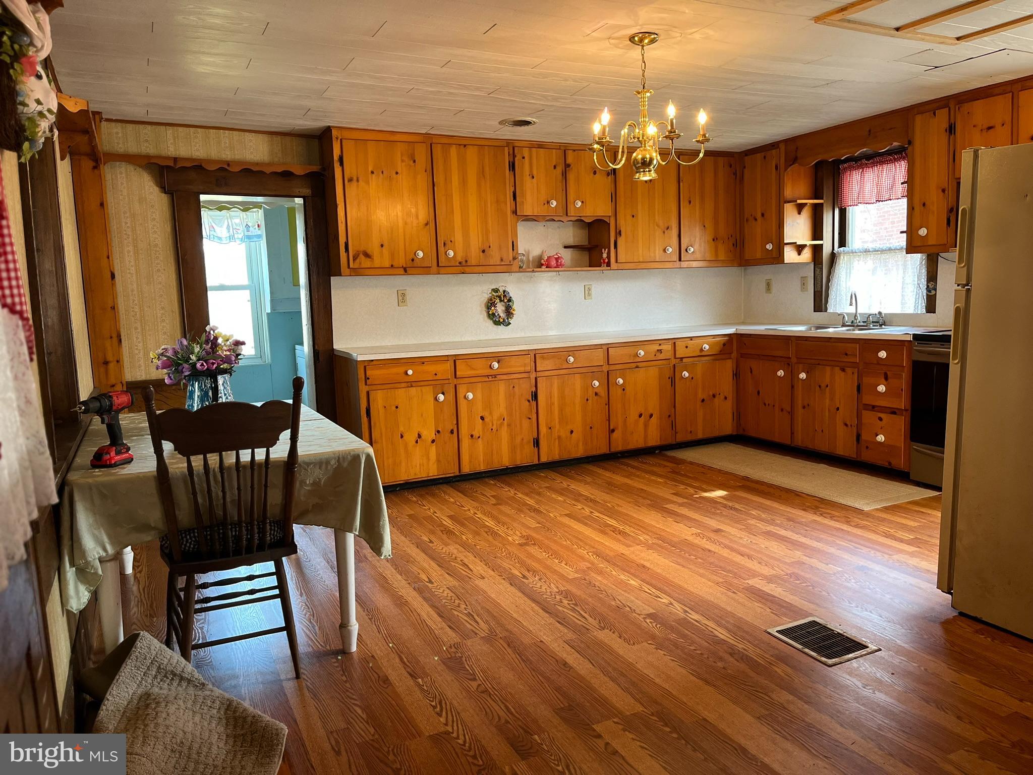 4164 Penns Valley Road Spring Mills, PA 16875 - Photo 13 of 49 a kitchen with stainless steel appliances granite countertop a stove a sink dishwasher and a microwave with wooden floor