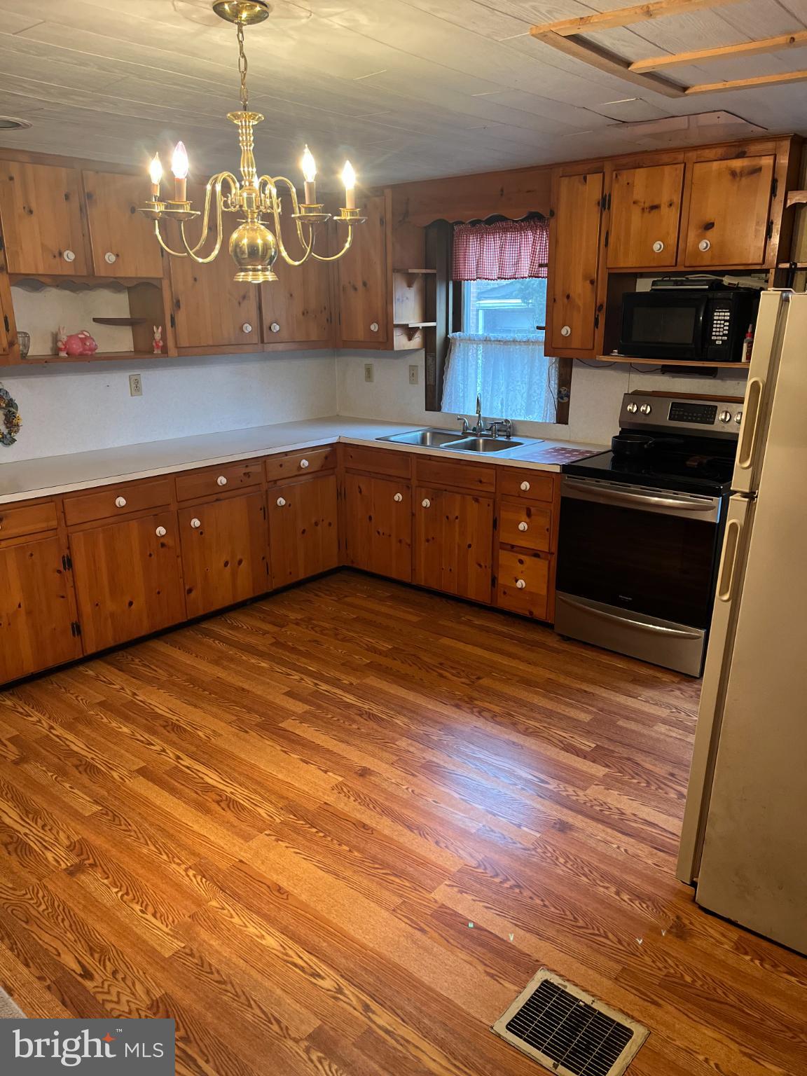 4164 Penns Valley Road Spring Mills, PA 16875 - Photo 15 of 49 a kitchen with stainless steel appliances kitchen island granite countertop a stove a sink and a microwave