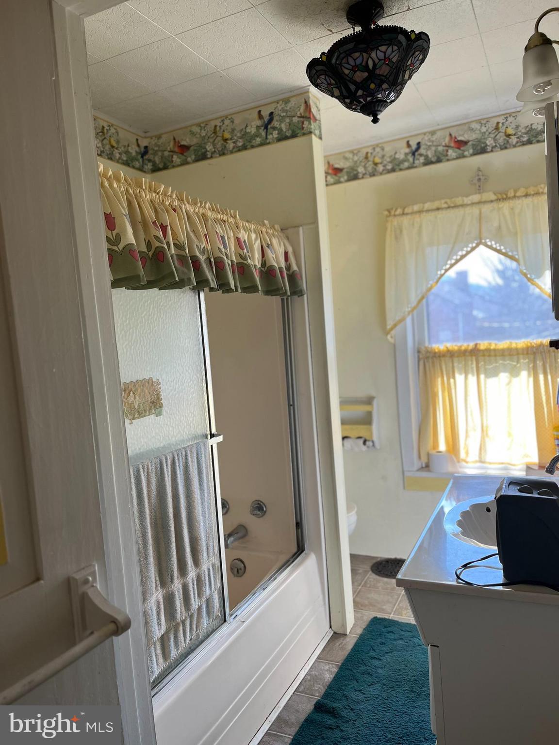 4164 Penns Valley Road Spring Mills, PA 16875 - Photo 30 of 49 a living room with a couch and a flat screen tv