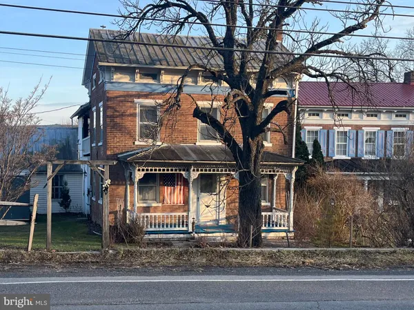 a kitchen with stainless steel appliances kitchen island granite countertop a stove a sink and a microwave