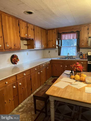 a kitchen with a sink cabinets and window