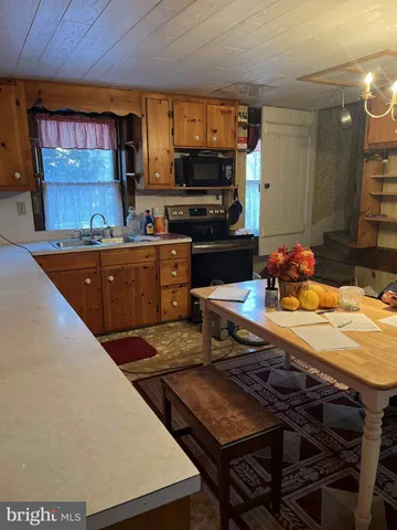 a kitchen with stainless steel appliances a stove a sink dishwasher and a microwave