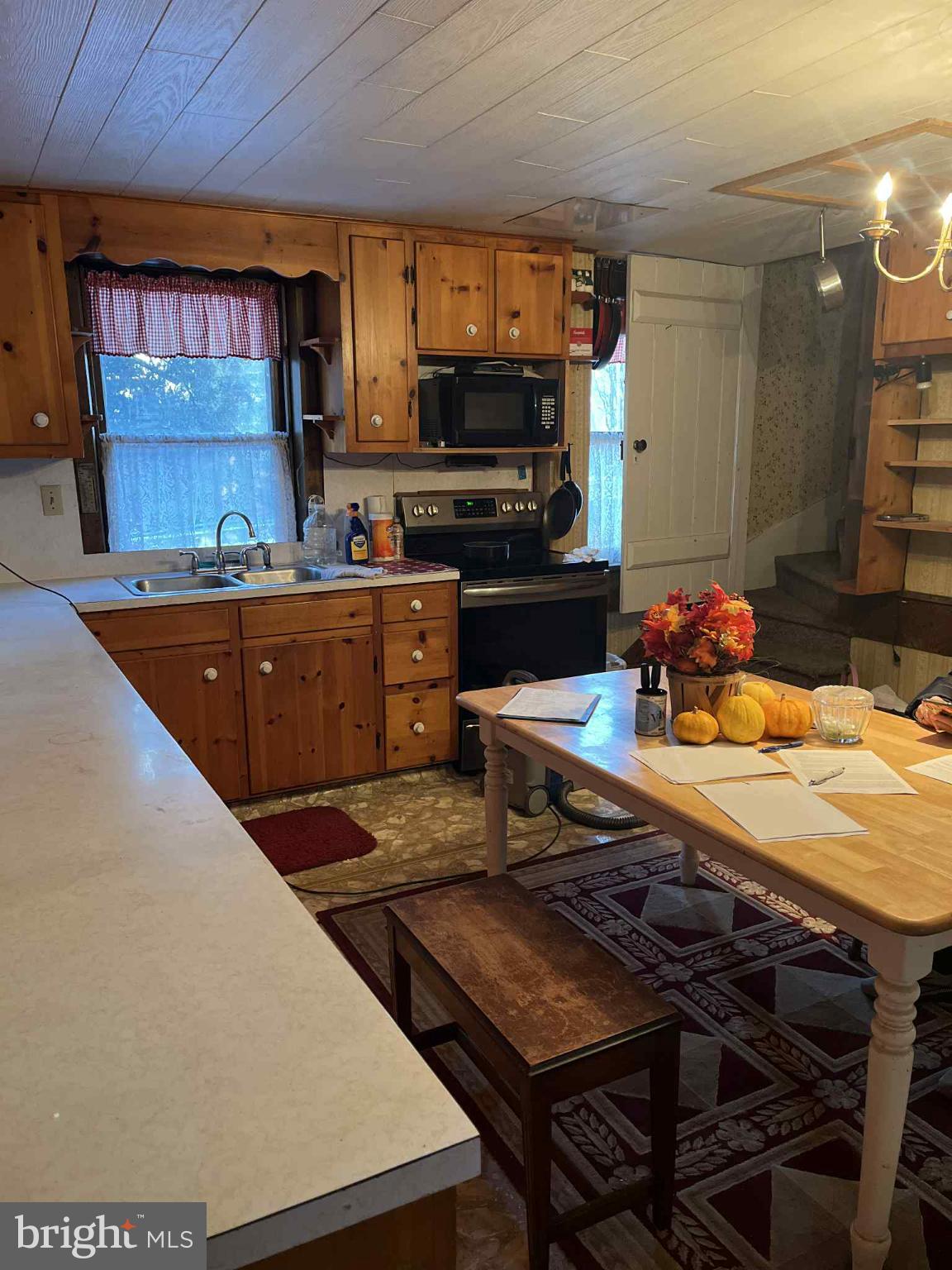 4164 Penns Valley Road Spring Mills, PA 16875 - Photo 7 of 34 a kitchen with stainless steel appliances a stove a sink dishwasher and a microwave