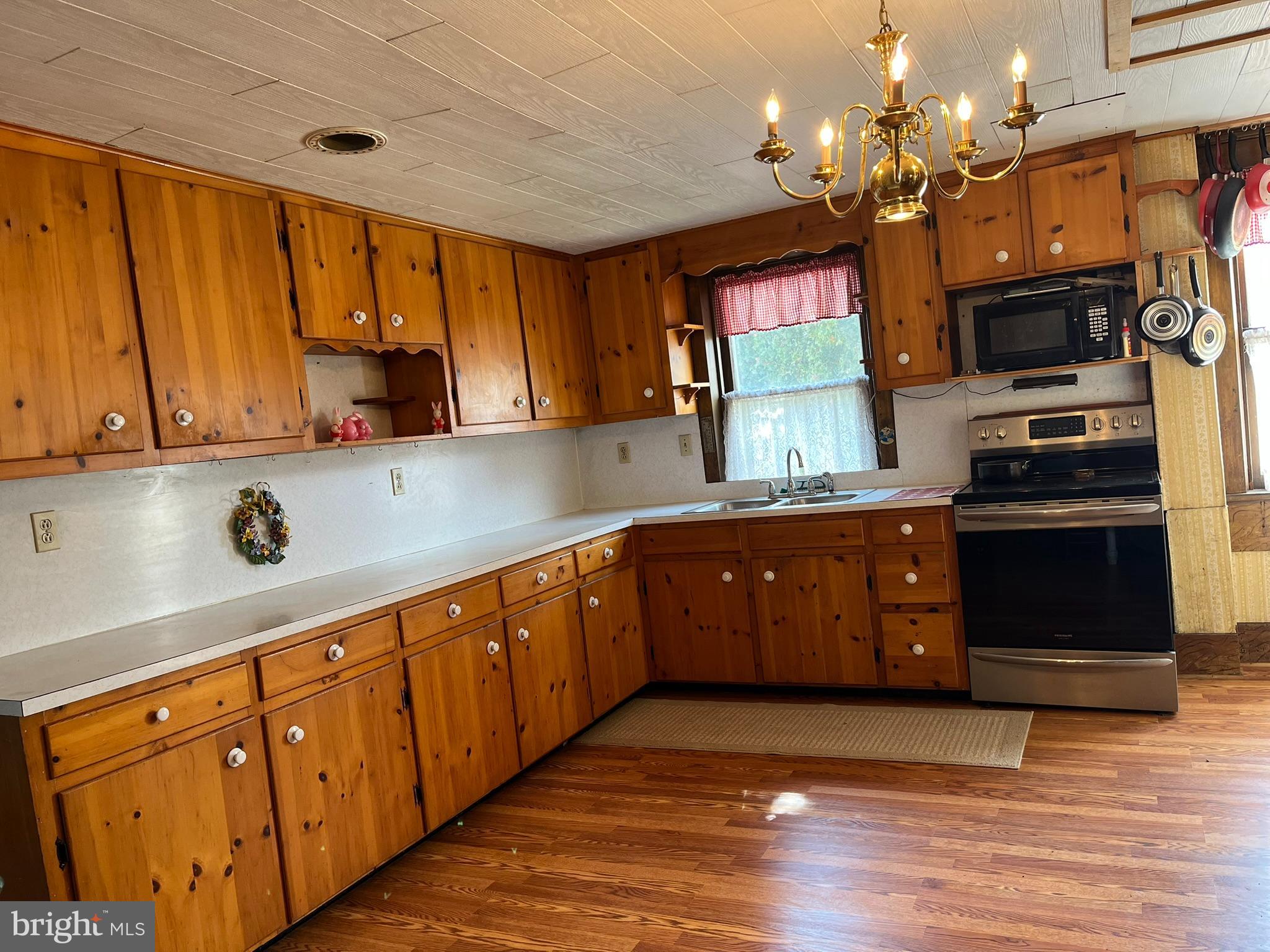 4164 Penns Valley Road Spring Mills, PA 16875 - Photo 8 of 49 a kitchen with stainless steel appliances granite countertop a refrigerator a sink dishwasher and wooden cabinets with wooden floor