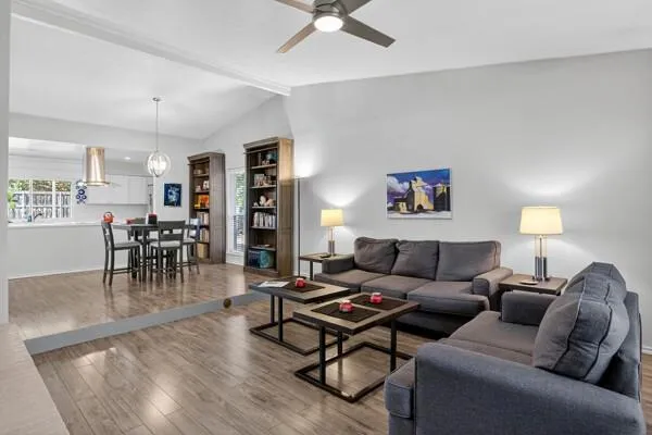 a living room with furniture and wooden floor