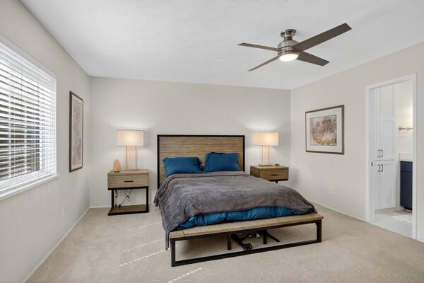 6331 North Jim Miller Road Dallas, TX 75228 - Photo 11 of 28 Bedroom with light colored carpet, a ceiling fan, and connected bathroom