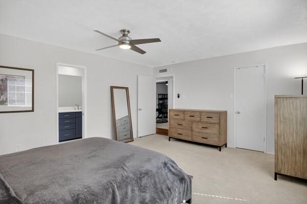 6331 North Jim Miller Road Dallas, TX 75228 - Photo 13 of 28 Bedroom with light colored carpet, ceiling fan, and ensuite bathroom