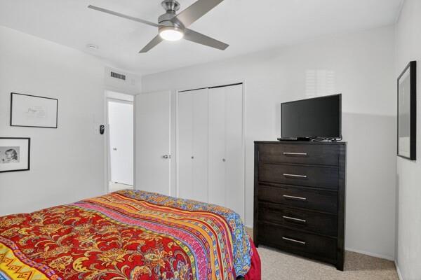 6331 North Jim Miller Road Dallas, TX 75228 - Photo 15 of 28 Bedroom with light colored carpet, ceiling fan, and a closet