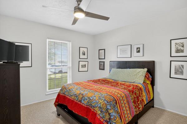 6331 North Jim Miller Road Dallas, TX 75228 - Photo 16 of 28 Bedroom featuring light colored carpet and a ceiling fan
