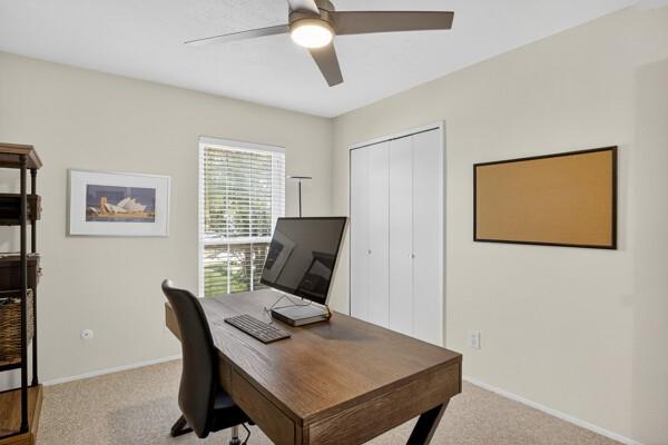 6331 North Jim Miller Road Dallas, TX 75228 - Photo 18 of 28 Home office with light colored carpet and a ceiling fan